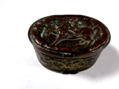 An antique embossed plated snuff box depicting figure on horseback