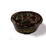 An antique embossed plated snuff box depicting figure on horseback