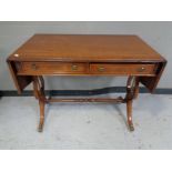 A Regency style inlaid mahogany sofa table fitted two drawers