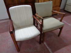 A stained beech framed armchair together with one other armchair