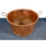 An antique copper twin handled pot,