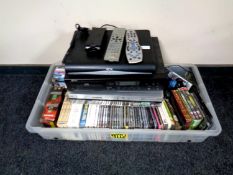 A crate containing DVDs, DVD box sets, computer games, PC Roms, together with a Panasonic DVD VCR,