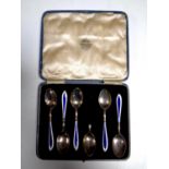 A set of five cased Birmingham silver and enamelled teaspoons together with one further damaged