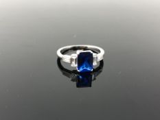 A sterling silver ring set with a blue stone,