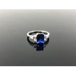 A sterling silver ring set with a blue stone,