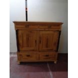 A 19th century pine double door linen cupboard fitted four drawers
