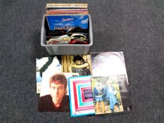 A box containing vinyl LPs and 7 inch singles to include Abba, Dexys Midnight Runners,