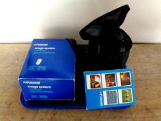 A Polaroid camera in bag together with Polaroid image system camera and image system special