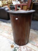 A 19th century mahogany cylindrical fronted corner cabinet