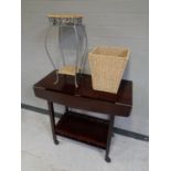 A contemporary two tier flap sided tea trolley together with a wicker and metal two tier plant