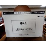 An LG 42UB820V Ultra HD Smart TV in original box with remotes