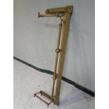 An antique brass fire fender