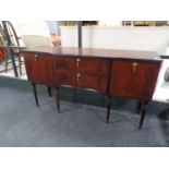 An inlaid mahogany Regency style sideboard on raised legs