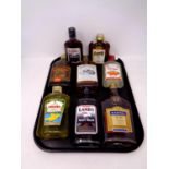 A tray containing eight bottles of alcohol to include Lamb's Navy Rum, Southern Comfort,