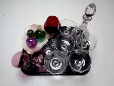 A tray containing assorted glassware to include paperweights, decanter with stopper,