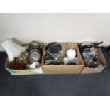 Three boxes containing kitchen utensils, pans, storage jars, candles, brass table lamp with shade,