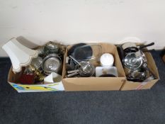 Three boxes containing kitchen utensils, pans, storage jars, candles, brass table lamp with shade,