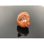 A carved hardwood netsuke - Rats playing in a pot