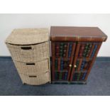 A contemporary double door cabinet in the form of books together with a metal and sea grass three