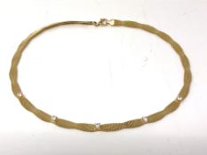 A gold plated on silver necklace set with stones