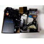 Two boxes containing PlayStation and PlayStation 2 consoles, leads and controllers,