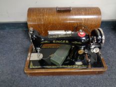 A 20th century oak cased Singer sewing machine (electrified,