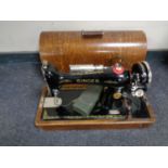 A 20th century oak cased Singer sewing machine (electrified,