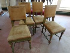 A set of four antique painted dining chairs upholstered in a gold fabric