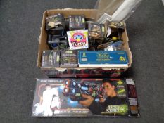 A box containing assorted toys to include Light Strike gun and launch systems, Furby,