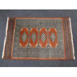 A fringed woolen Persian rug of geometric design