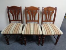 A set of six stained pine chairs