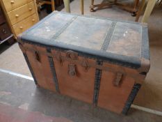 An antique metal bound shipping trunk