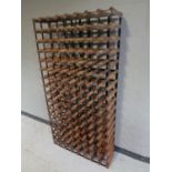 A large metal and pine wine rack