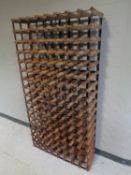 A large metal and pine wine rack
