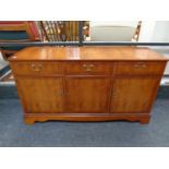 A Strong Bow Furniture inlaid yew wood triple door sideboard fitted two drawers