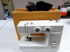 A Janome Model 1560 electric sewing machine in original box