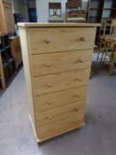 A contemporary pine six drawer chest