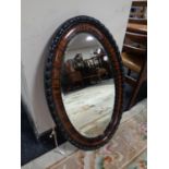 An Edwardian oval framed bevel edged mirror