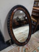 An Edwardian oval framed bevel edged mirror