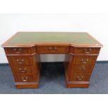 A Strong Bow Furniture yew wood twin pedestal writing desk with a green leather inset panel