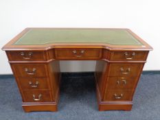 A Strong Bow Furniture yew wood twin pedestal writing desk with a green leather inset panel
