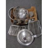 A box of vintage car hub caps, grills,