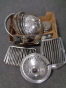 A box of vintage car hub caps, grills,