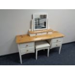 A pine topped four drawer dressing table on painted base with stool and mirror