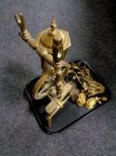 A tray containing a brass ornament of a spinning wheel, a brass lantern table lamp, wall sconces,