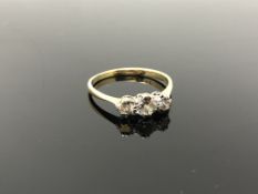 An 18ct gold and platinum three stone diamond ring, size R CONDITION REPORT: 2.