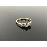 An 18ct gold and platinum three stone diamond ring, size R CONDITION REPORT: 2.