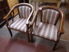 A pair of wood framed tub chairs upholstered in a striped fabric