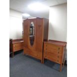 A three piece 20th century oak bedroom suite comprising of mirror door wardrobe, fitted a drawer,