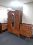 A three piece 20th century oak bedroom suite comprising of mirror door wardrobe, fitted a drawer,